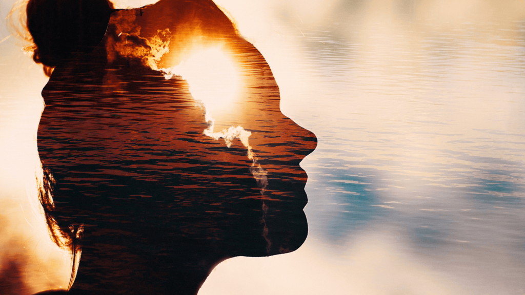 Silhouette of a woman's face in profile superimposed over a water background